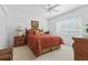 Bright bedroom features a ceiling fan, window, and comfortable furnishings at 21312 Preservation Dr, Land O Lakes, FL 34638