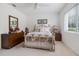 Bright bedroom with floral accents and a large window providing natural light at 21312 Preservation Dr, Land O Lakes, FL 34638