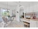 Cozy dining area with glass table, white chairs, tile floors, and natural light coming in from a large window at 21312 Preservation Dr, Land O Lakes, FL 34638