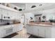 Well-lit kitchen with white cabinetry, tile backsplash, and modern appliances, offering a functional layout at 21312 Preservation Dr, Land O Lakes, FL 34638