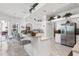 Bright kitchen with white cabinets, bar seating, stainless steel appliances, and views to the outdoor space at 21312 Preservation Dr, Land O Lakes, FL 34638
