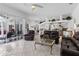 Spacious living room with tile flooring, comfortable leather seating, and an open view to the kitchen at 21312 Preservation Dr, Land O Lakes, FL 34638