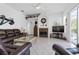 Comfortable living room features a fireplace, plush leather seating, and a view of the pool at 21312 Preservation Dr, Land O Lakes, FL 34638