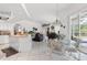 Open concept living space with kitchen, dining, and lounge areas, featuring tile flooring and ample natural light at 21312 Preservation Dr, Land O Lakes, FL 34638