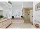 Bright bathroom with a unique pink tub, walk-in shower, and arched window for natural light at 21312 Preservation Dr, Land O Lakes, FL 34638