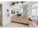 Spacious bathroom featuring dual sinks, ample counter space, and a large framed mirror at 21312 Preservation Dr, Land O Lakes, FL 34638