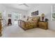 Bright main bedroom featuring elegant furnishings, plush carpet, and access to outdoor lanai at 21312 Preservation Dr, Land O Lakes, FL 34638