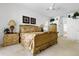 Comfortable bedroom with a decorative wood bed frame, soft carpet, and an ensuite bath at 21312 Preservation Dr, Land O Lakes, FL 34638