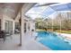 Backyard pool area with a screened enclosure and a patio with furniture at 21312 Preservation Dr, Land O Lakes, FL 34638