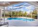 Screened pool with a clear blue water and outdoor seating at 21312 Preservation Dr, Land O Lakes, FL 34638