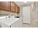 Laundry room with washer, dryer, and ample cabinet storage at 3211 Banyan Hill Ln, Land O Lakes, FL 34639