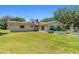 Ranch-style home with a large grassy yard and garden beds at 19351 Yontz Rd, Brooksville, FL 34601