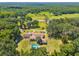 Aerial view of home, pool, and vast green landscape at 19351 Yontz Rd, Brooksville, FL 34601