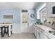 Bright kitchen with white cabinets, light blue walls, and a view of the backyard at 19351 Yontz Rd, Brooksville, FL 34601