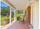 Inviting front porch with rocking chair and view of the landscape at 19351 Yontz Rd, Brooksville, FL 34601