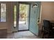 Bright entryway with light blue door and view into backyard at 1829 Lake Cypress Dr # 503, Safety Harbor, FL 34695