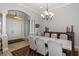 Elegant dining room with marble-top table and chandelier at 1453 El Pardo Dr, Trinity, FL 34655