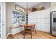 Charming kitchen nook with banquette seating, wood table, and ample cabinet storage at 11242 Riddle Dr, Spring Hill, FL 34609