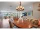 Bright dining area with a round wooden table and wicker chairs at 3154 Brigantine Ct, New Port Richey, FL 34652