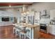 Kitchen island with seating and granite countertop, open to living area at 3154 Brigantine Ct, New Port Richey, FL 34652