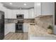 Modern kitchen with white cabinets, granite counters at 3154 Brigantine Ct, New Port Richey, FL 34652