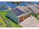 Attached three-car garage with solar panels on the roof at 3154 Brigantine Ct, New Port Richey, FL 34652