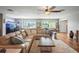 Sunlit living room with a large sectional sofa and hardwood floors at 3154 Brigantine Ct, New Port Richey, FL 34652