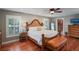 Main bedroom with king bed, wood furniture, and window seating at 3154 Brigantine Ct, New Port Richey, FL 34652