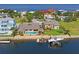 Aerial view of waterfront home with boat lift and pool at 3154 Brigantine Ct, New Port Richey, FL 34652