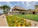 Landscaped backyard with tiki hut and lush flowers at 3154 Brigantine Ct, New Port Richey, FL 34652