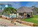 Landscaped backyard with a tiki hut and pool at 3154 Brigantine Ct, New Port Richey, FL 34652