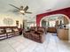 Spacious living room with leather furniture and archway to kitchen at 4040 Hermosa Blvd, Hernando Beach, FL 34607