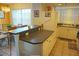 Kitchen boasts a breakfast bar, dark countertops, and white cabinets at 2077 Wetland Pt # 1202, Lutz, FL 33558