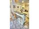 White kitchen with breakfast bar and appliances at 2077 Wetland Pt # 1202, Lutz, FL 33558