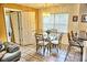 Small dining area with glass-top table and four chairs at 2077 Wetland Pt # 1202, Lutz, FL 33558