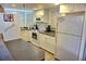 White kitchen with corner sink and appliances at 2077 Wetland Pt # 1202, Lutz, FL 33558
