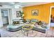 Living room with an L-shaped sofa, coffee table, and view into kitchen at 2077 Wetland Pt # 1202, Lutz, FL 33558