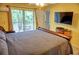 Spacious bedroom with a queen-size bed and balcony access at 2077 Wetland Pt # 1202, Lutz, FL 33558
