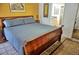 Spacious primary bedroom with a sleigh bed and ensuite bathroom access at 2077 Wetland Pt # 1202, Lutz, FL 33558