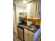 Small kitchenette with a microwave, coffee maker, and mini-fridge at 2077 Wetland Pt # 1202, Lutz, FL 33558