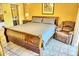 Bedroom with a king-size sleigh bed and a comfortable armchair at 2077 Wetland Pt # 1202, Lutz, FL 33558