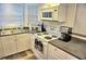 White kitchen with built in microwave and stovetop at 2077 Wetland Pt # 1202, Lutz, FL 33558