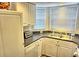 Bright kitchen features ample cabinetry, a double sink, and modern appliances at 2077 Wetland Pt # 1202, Lutz, FL 33558