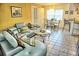 Open living and dining area with L-shaped sofa and dining table at 2077 Wetland Pt # 1202, Lutz, FL 33558