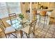 Dining area with glass-top table and four chairs near kitchen at 2077 Wetland Pt # 1202, Lutz, FL 33558