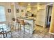 White kitchen with breakfast bar and appliances at 2077 Wetland Pt # 1202, Lutz, FL 33558