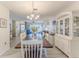 Bright dining room featuring a wood table, white chairs, and a built-in hutch at 2639 Royal Ridge Dr, Spring Hill, FL 34606