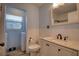 Bright bathroom featuring white cabinetry, a toilet, and a sink with black fixtures at 6629 Harbor Dr, Hudson, FL 34667