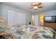 Relaxing bedroom with palm-themed bedding, closet, and a TV on the dresser at 6629 Harbor Dr, Hudson, FL 34667