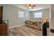 Cozy bedroom with hardwood floors, two windows, and a comfortable bed with palm-themed bedding at 6629 Harbor Dr, Hudson, FL 34667